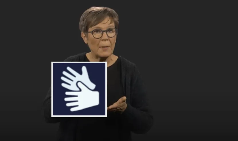 Skärmdump från film med teckenspråkstolken i bild. Loggan för teckenspråk ligger till vänster i bilden.